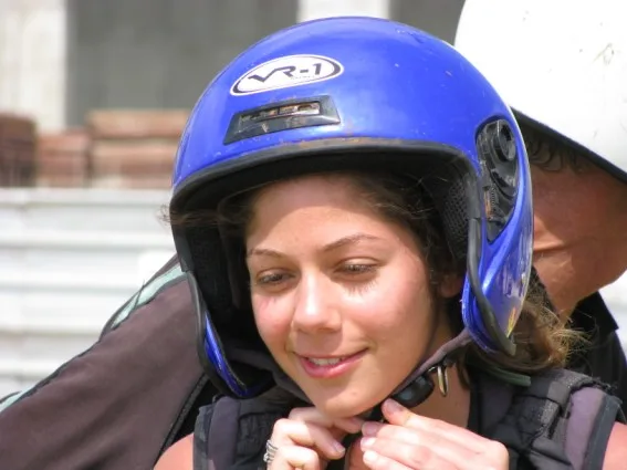 נוסעת סוגרת את רצועת הקסדה לפני הטיסה
